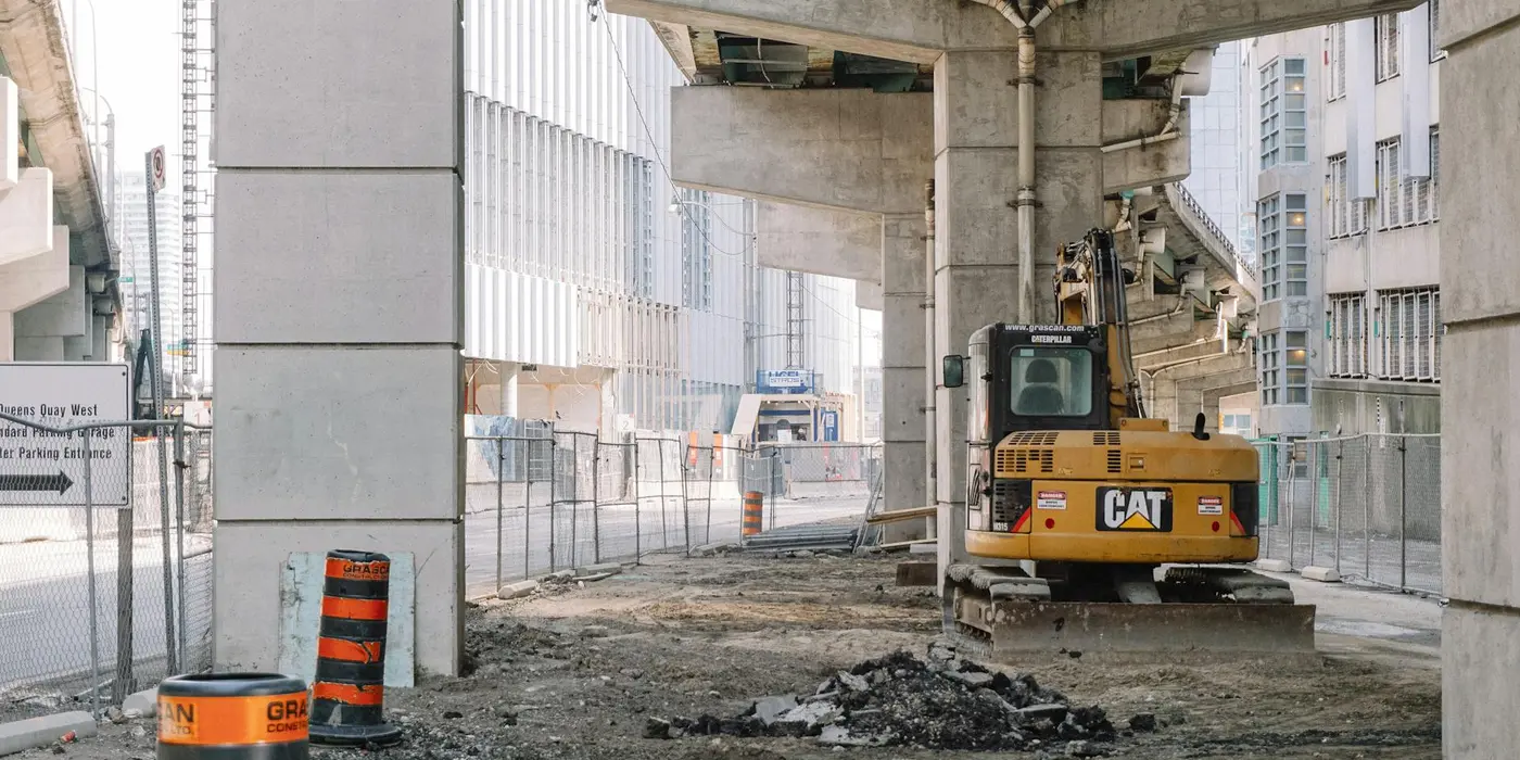 a bulldozer removing concrete under a highway bridge from CONCRETE CREATIONS LLC HOUSTON in Houston, TX - CONCRETE POURING SERVICES