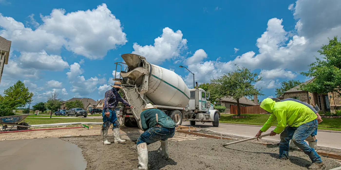 concrete workers pouring concrete and spreading it for a new foundation from CONCRETE CREATIONS LLC HOUSTON in Houston, TX - CONCRETE RAISING SERVICES