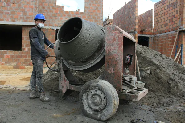 a concrete worker using a cement mixer from CONCRETE CREATIONS LLC HOUSTON in Houston, TX - CONCRETE WORK IN HOUSTON